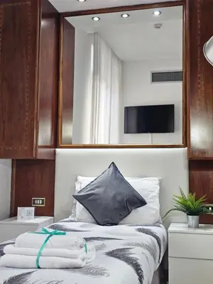 a bedroom with a bed with towels on it at Hotel Max in Rome