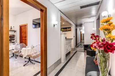 a dining room with a table and a mirror at Hotel Max in Rome