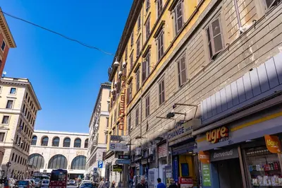 a group of buildings on a city street with people at Hotel Max in Rome