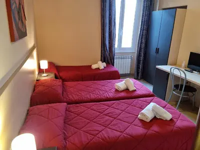 two beds in a room with pink sheets and towels at Hostel Mosaic in Rome