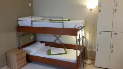 two bunk beds in a small room with a lamp at Hostel Mosaic in Rome