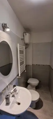 a bathroom with a white sink and a toilet at Hostel Mosaic in Rome