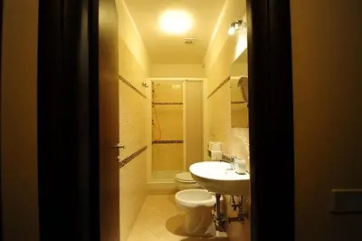 a bathroom with a toilet and a sink at Hotel Mosaic Central Rome in Rome