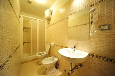 a bathroom with a sink and a toilet at Hotel Mosaic Central Rome in Rome