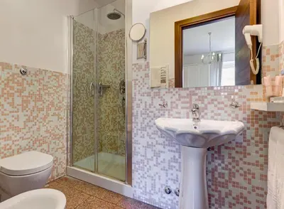 a bathroom with a sink and a shower at Little Rhome Suites in Rome