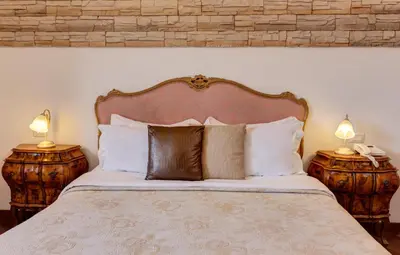 a bedroom with a large bed with two night stands at Little Rhome Suites in Rome