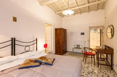 a bedroom with a large bed and a desk at B&B La Scalinatella in Rome