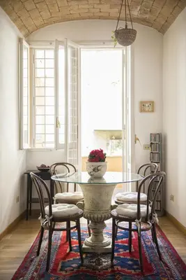 a dining room with a glass table and chairs at B&B La Scalinatella in Rome