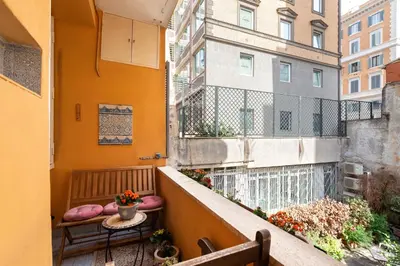an apartment balcony with a table and a window at B&B La Scalinatella in Rome