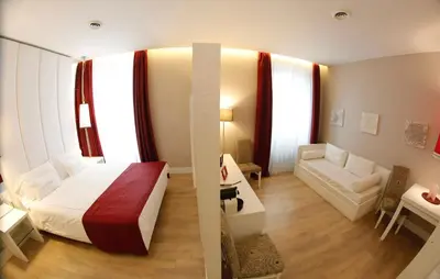 a bedroom with a bed and a living room at Tullia&Prisca Relais in Rome
