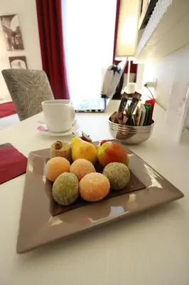 a plate of fruit sitting on a table at Tullia&Prisca Relais in Rome