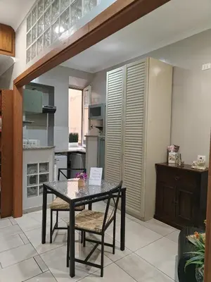 a dining room with a table and chairs in a kitchen at Domus Roxy in Rome