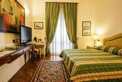 a hotel room with a bed and a desk at Casa Riz in Rome