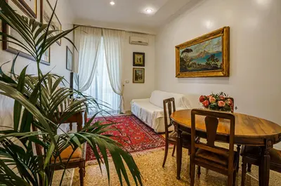 a living room with a table and a bed at Casa Riz in Rome