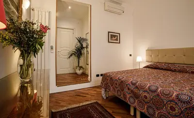 a hotel room with a bed and a large mirror at Casa Riz in Rome