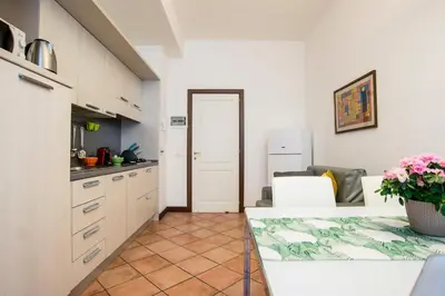 a kitchen with a counter and a table in a room at SWEETSUITE Rome in Rome