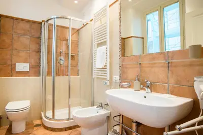a bathroom with a sink and a toilet and a shower at SWEETSUITE Rome in Rome
