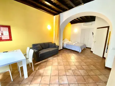 a living room with a couch and a table at SWEETSUITE Rome in Rome