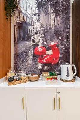 a cabinet with a picture of a scooter on it at Next Stop St Peter Rome in Rome