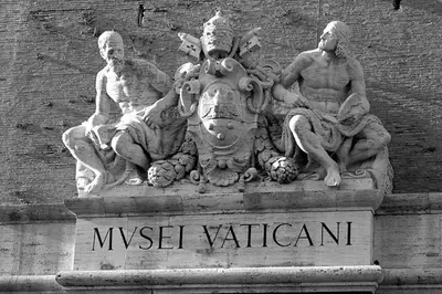 a statue of three men sitting on top of a building at Next Stop St Peter Rome in Rome