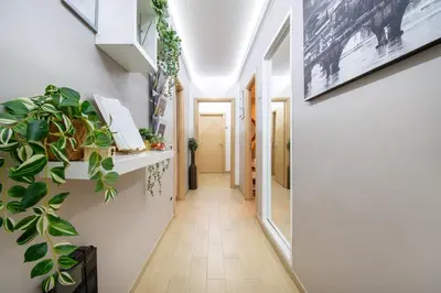 a hallway with white walls and plants on the walls at Next Stop St Peter Rome in Rome