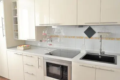 a kitchen with white cabinets and a sink at Aquarius Inn in Rome