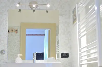 a bathroom with a mirror and a sink at Aquarius Inn in Rome