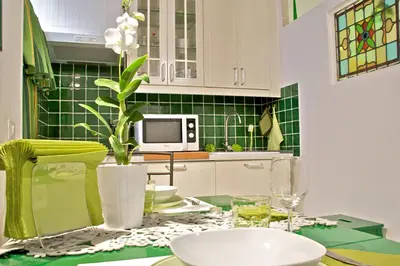 a kitchen with a table with a vase of flowers at Nostromondo Apartments in Rome City Centre in Rome
