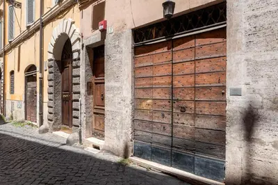 a building with wooden doors on a street at Nostromondo Apartments in Rome City Centre in Rome