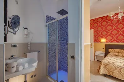 a bathroom with a tub and a bedroom with a bed at Quality in Rome in Rome