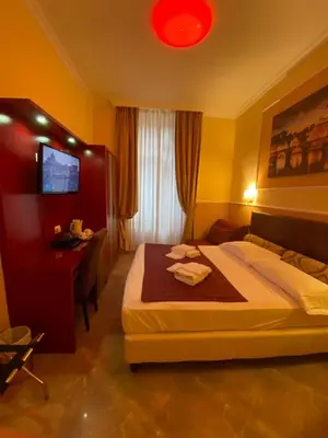 a bedroom with a bed and a desk and a television at Quality in Rome in Rome