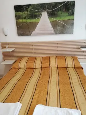 a bed in a room with a picture on the wall at Testa Gioacchino B&B in Rome