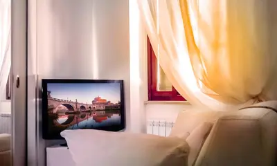 a living room with a tv and a couch at Casina Tiberina in Rome