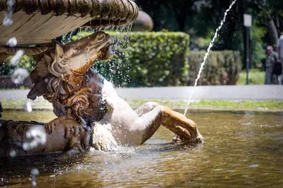 a statue of a woman sitting in a fountain at Casina Tiberina in Rome