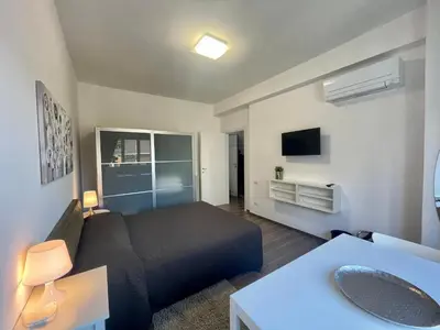 a room with a bed and a couch and a tv at Dreamsrome Lux in Rome