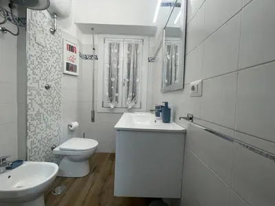 a white bathroom with a sink and a toilet at Dreamsrome Lux in Rome