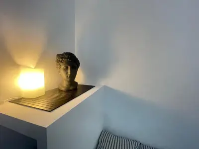 a bust of a head on a shelf with a light at Dreamsrome Lux in Rome