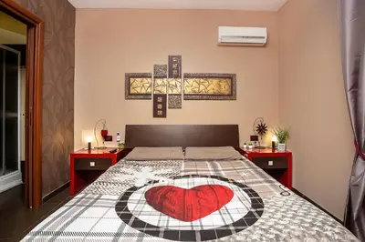 a bedroom with a bed with a heart on it at Eritrea Suite in Rome