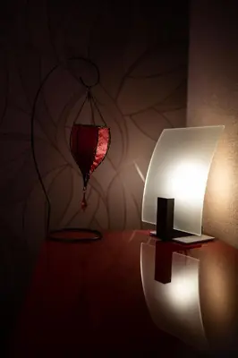 a lamp on a table next to a red lamp at Eritrea Suite in Rome