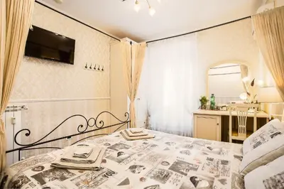 a bedroom with a bed and a bathroom at Eritrea Suite in Rome