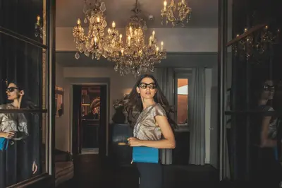 a woman standing in front of a mirror at DOM Hotel Roma - Preferred Hotels & Resorts in Rome