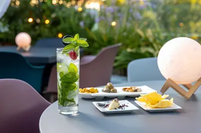 a table with plates of food and a vase with a strawberry at DOM Hotel Roma - Preferred Hotels & Resorts in Rome