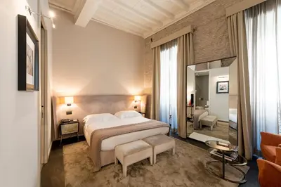 a bedroom with a large bed and a bathroom at DOM Hotel Roma - Preferred Hotels & Resorts in Rome