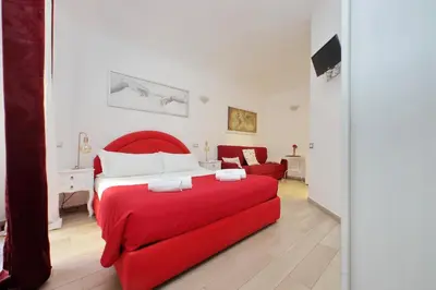 a bedroom with a red bed and a red couch at Dream City Rome in Rome