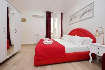 a bedroom with a red bed with a red blanket at Dream City Rome in Rome