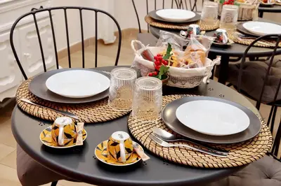 a black table with plates and dishes on it at Dream City Rome in Rome