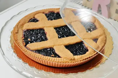 a pie with a cross on top of it on a glass plate at Dream City Rome in Rome
