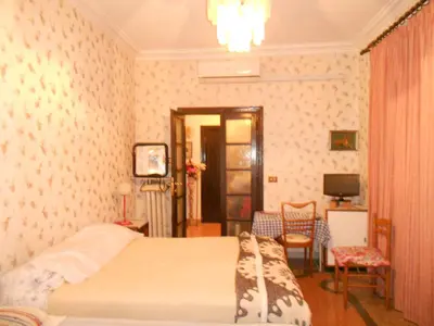 a bedroom with a bed in a room with wallpaper at Sidereus in Rome