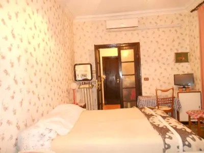 a bedroom with a bed in a room with wallpaper at Sidereus in Rome