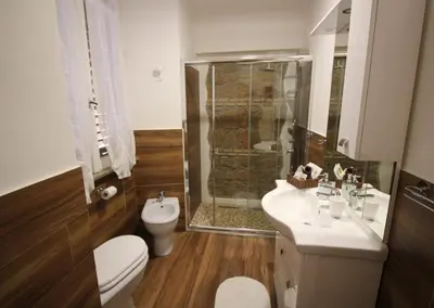 a bathroom with a shower and a toilet and a sink at Freedom Love B&B in Rome